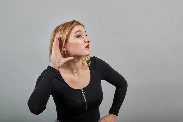 Mädchen in schwarzer Jacke interessiert Frau belauscht, hält ihre Hand ans Ohr — Stockfoto