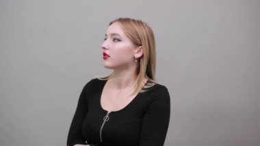 Young blonde girl in black jacket terrified woman shows emotion of fear