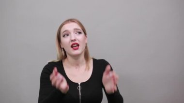 girl in jacket upset woman in despair holds hands near mouth, frightened eyes