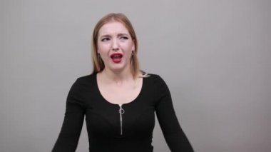 Young blonde girl in black jacket irritated woman suffering from pain in ears
