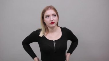 girl in black jacket dissenting woman returns thumbs down, shows protest dissent
