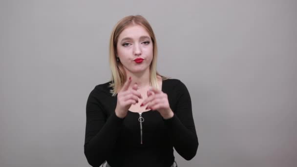 Insincere woman shows a fake smile, pulls the skates of lips with index fingers — Stockvideo
