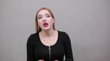 Young blonde girl in black jacket terrified woman shows emotions of fear