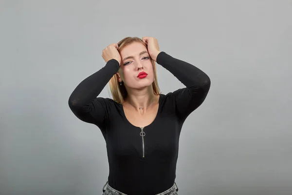 Girl in jacket tired woman is suffering from headache, holding head with hands — Stock Fotó