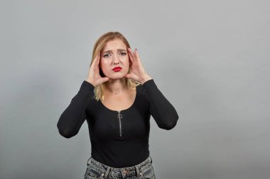 girl in jacket teasing of women suffering from headache touching hands to head
