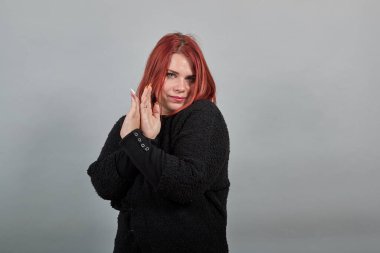 fat girl in sweater dissenting woman shows arms crossed as sign of resistance