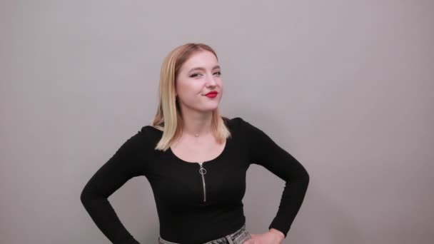 Young blonde girl in black jacket happy woman smiles and gives a thumbs up — Stockvideo