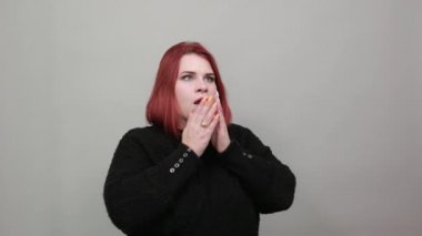 fat girl in black sweater shocked woman covered her face with hand in surprise