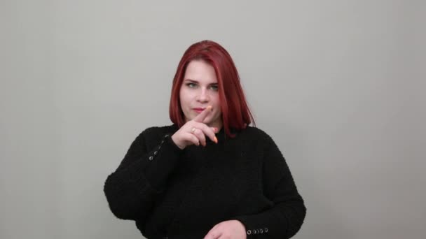 Fat girl in black sweater secret woman wants silence, holds index finger mouth — Stock video