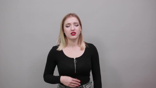 Blonde girl in black jacket suffering woman suffers from heart pain, heartache — Stockvideo