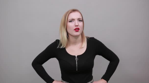 Young blonde girl in black jacket frightened woman gestures with her hands — Stock video