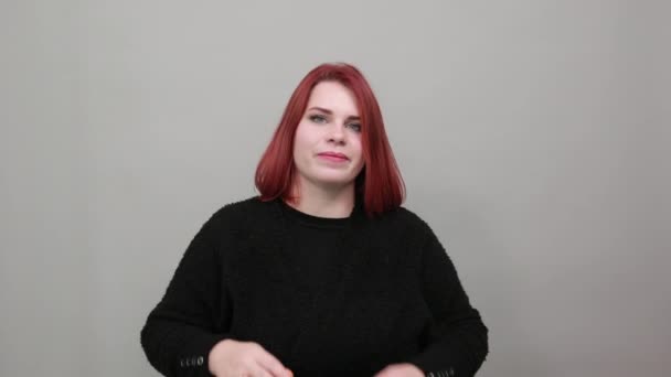 Молодая рыжая толстая леди в черном свитере нежная женщина прикасается к лицу руками — стоковое видео