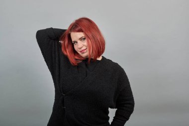 Young redhead fat lady in black sweater rear woman posing for the camera