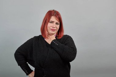 unhappy woman is suffering from a sore throat for possible cold or flu