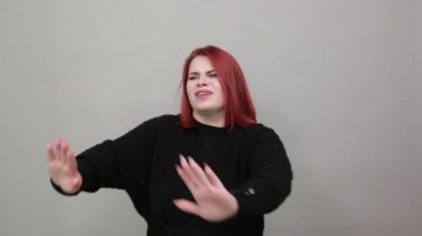 fat lady offended woman shows stop sign with her hands, no, shows disagreement