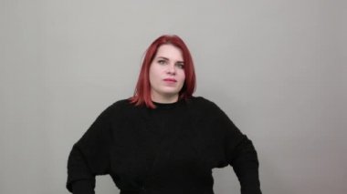 fat lady in black sweater upset woman put her hands in fists and raised them