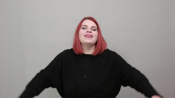 Rothaarige Dame im schwarzen Pullover glückliche Frau hob die Hände und schüttelte sie lächelnd — Stockvideo