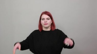 redhead fat lady in black sweater annoyed, upset woman holding hair in despair