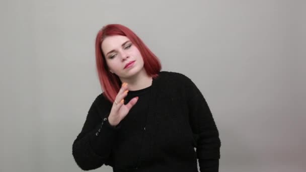 Young redhead fat lady in black sweater gentle woman gently touches hand to face — Stockvideo