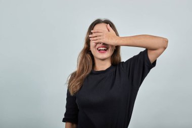 Mutlu kız gülümsüyor ve gözlerini kapıyor, sürprizi bekliyor, bir hediye.