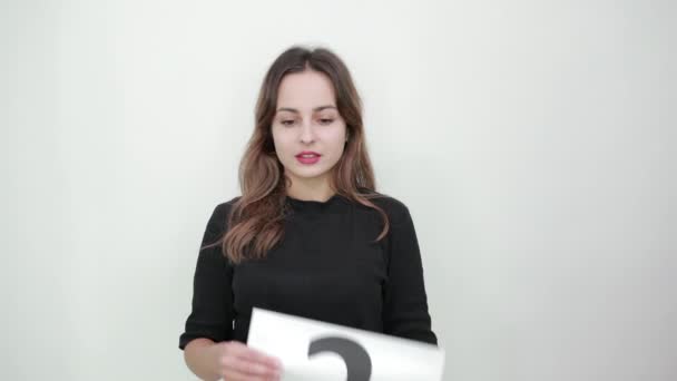 Girl Does Not Know What To Do. Holding Sheet Of White Paper With Question Mark — Stock Video