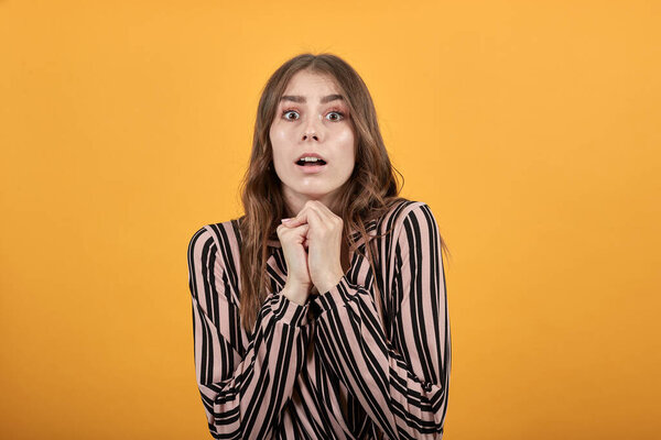 Scared Girl Puts Hands Together, Looks Ahead. Concept Of People Who Are Afraid