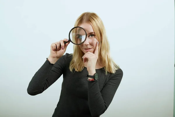 Focused Girl Looks Through Magnifying Glass, Big Eye. Concept Of Research, Study — Stock Photo, Image