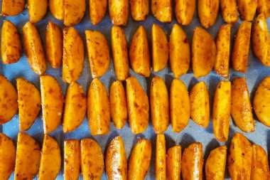 Kağıt üzerinde fırında patates dilimleri..