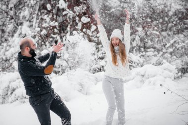 Ormanda karla oynayan çift.