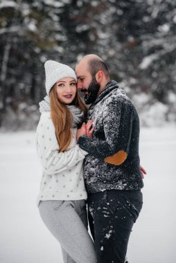 Ormanda karla oynayan çift.