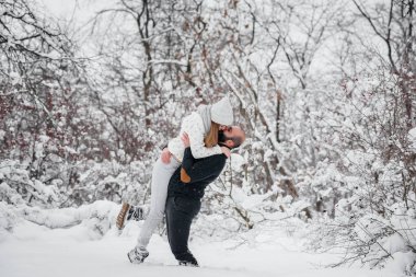 Ormanda karla oynayan çift.