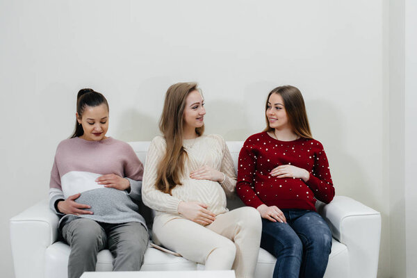 Pregnant girls are waiting for the doctor in the waiting room