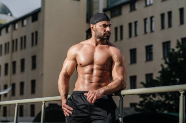 Seksi sporcu berbat ve üstsüz poz veriyor. Avrupa.