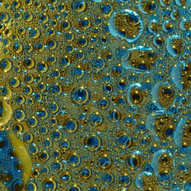 Büyük yarı saydam mavi-altın halkalar ve siyah küreler mavi-altın arka planda yer almaktadır. Kozmik soyutlama. 