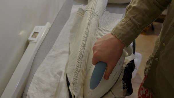 Tailor ironing the horse hair canvas of bespoke made to measure suit. The floating canvas is loosely hand stitched in place between the outer jacket fabric and the inner lining — Stock Video