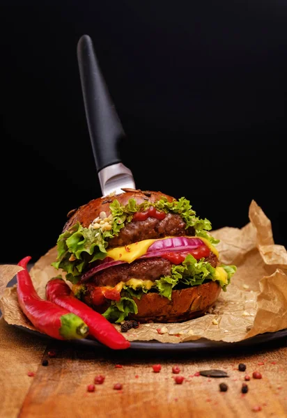 Tasty grilled double burger cheeseburger with pepper and salad