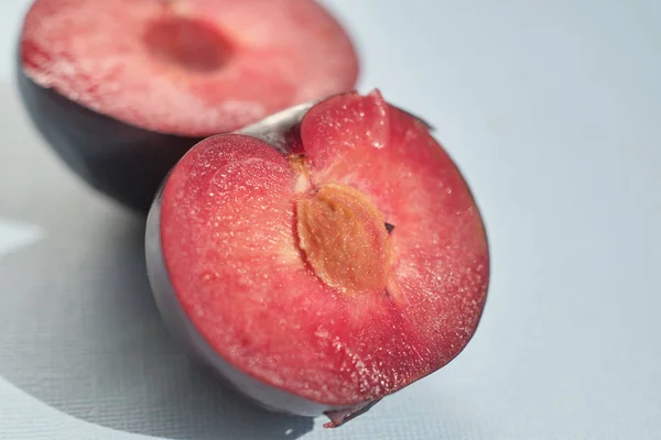 Sliced plum on light background