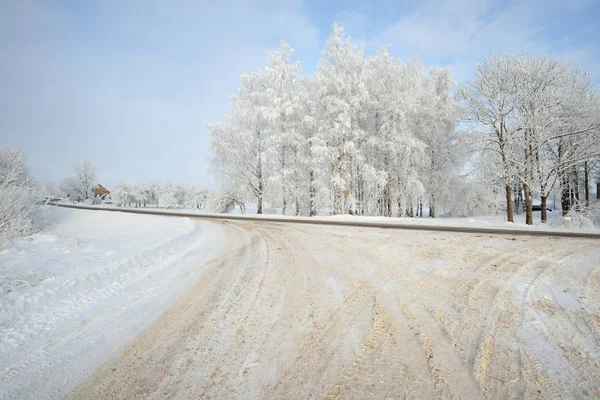 Tracks on a snowy rural road — Stock Photo, Image