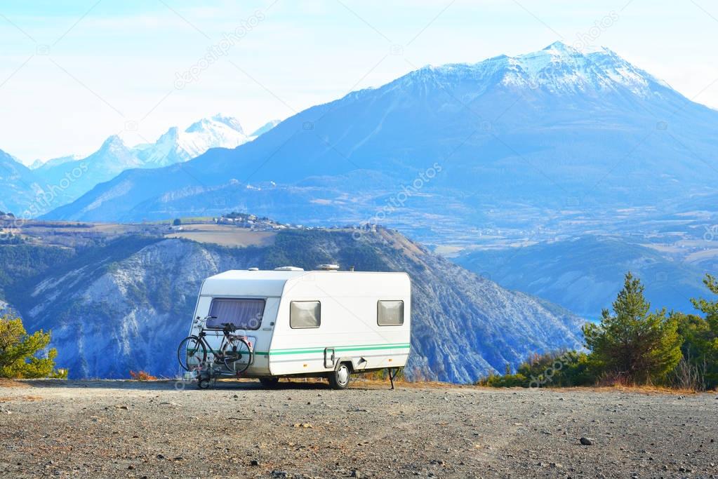 Caravan with a bike parked on a mountaintop 