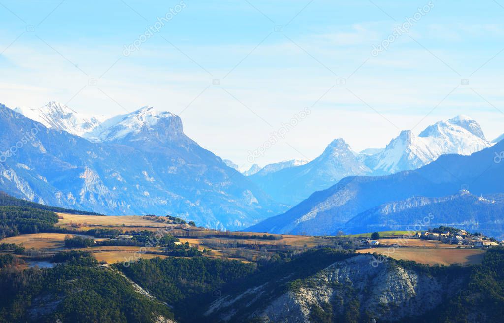 Alps mountaintops and a mountain village near lake