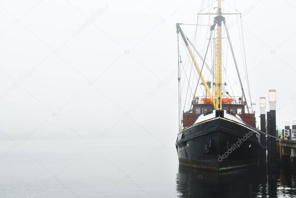 Fishing boat moored to a pier 