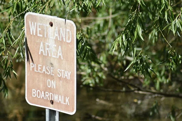Bright Weathered Maroon Sign Wetland Area Please Stay Boardwalk — Stock Photo, Image