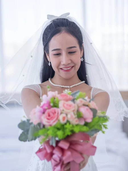 Happiness asian bride with colorful bridal bouquet in the wedding day. Bride with bridal bouquet.