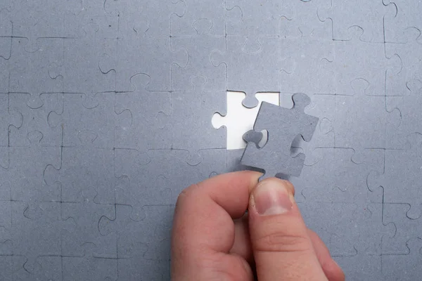 Mâna Umană Plasează Piesă Puzzle Încercând Rezolve Puzzle Fundal — Fotografie, imagine de stoc