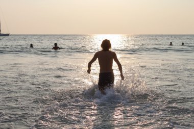 Deniz çalışan ve su sıçramasına adam siluet. Kıyısında tatil