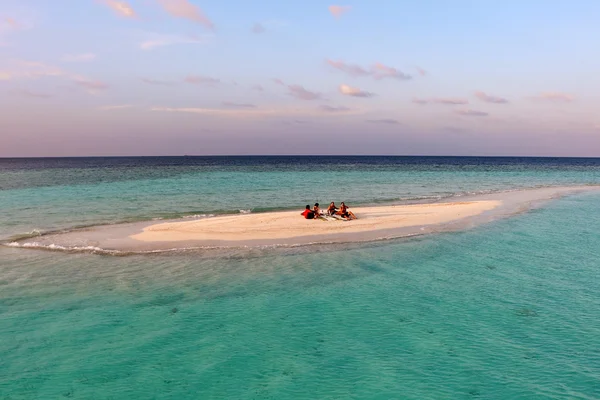 SMALL ISLAND, MALDIVES -FEBRUARY 09:  small island with relaxing people in the Maldives sea — Stock Photo, Image