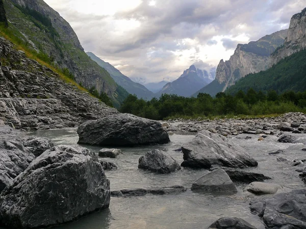 Alpine mountain water stream at sunset in Switzerland — Stock Photo, Image