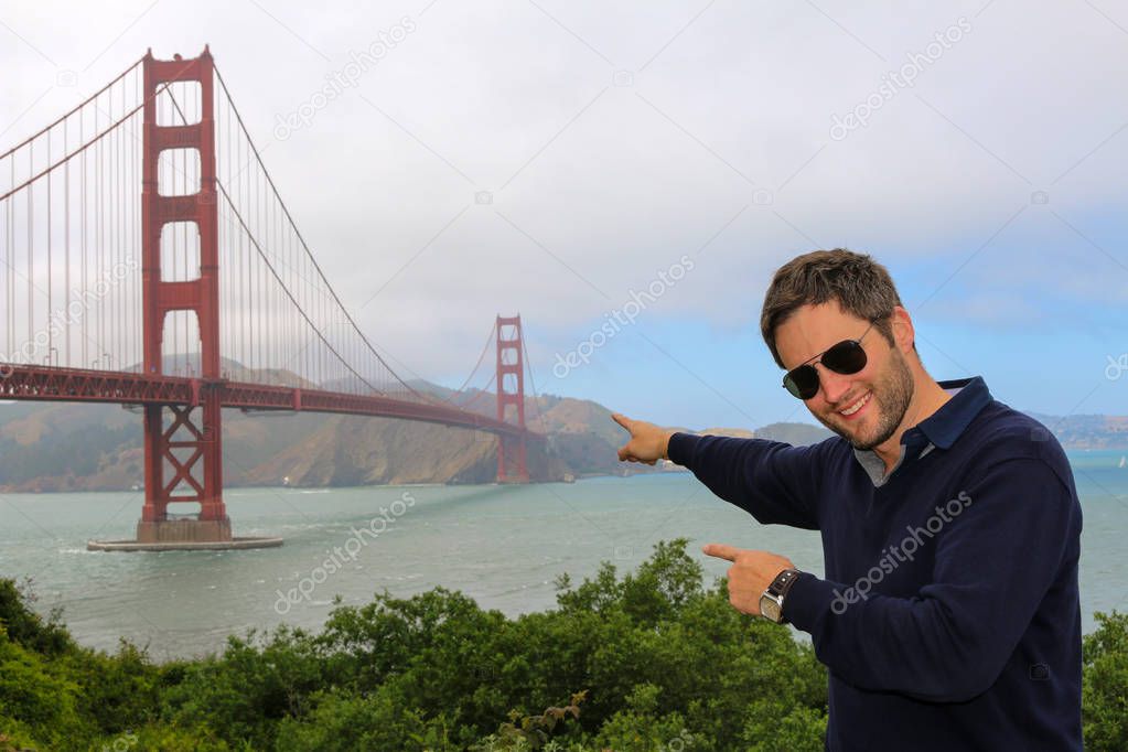 young man enjoying time and famous sightseeing in san francisco - golden gate bridge