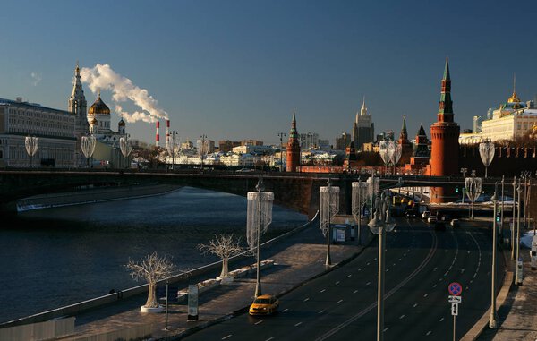 View of the Moscow Kremlin, a stone bridge and the Moscow River.