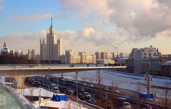 01 February 2018, Moscow, Russia, View of the floating bridge with visitors attractions and the skyscraper on Kotelnicheskaya Embankment.
